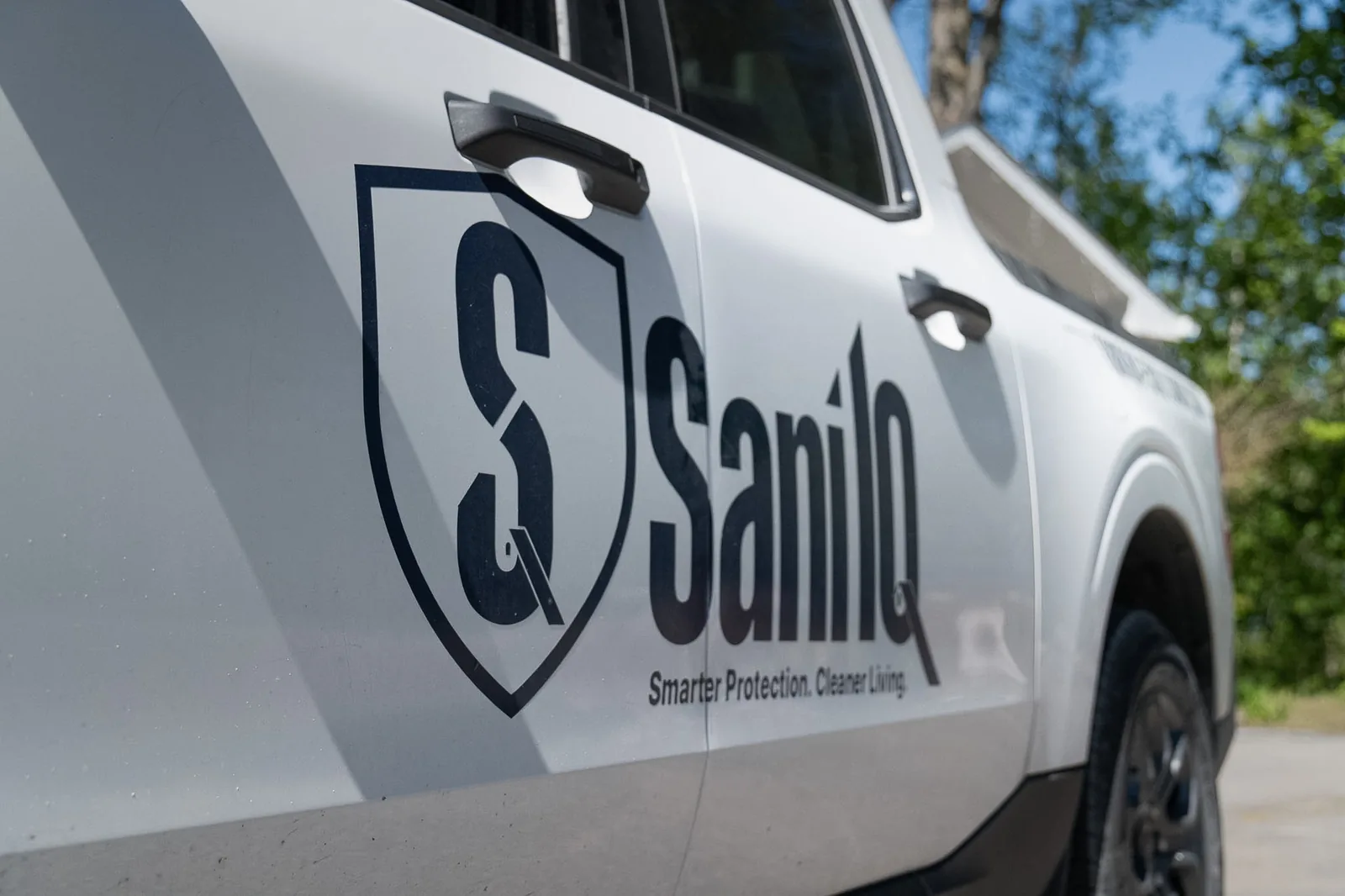 Sani IQ branded pest control service vehicle